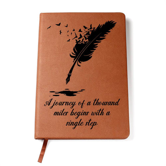 Brown vegan leather graphic journal with feather design and inspirational quote "A journey of a thousand miles begins with a single step"